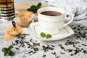 Cup tea with mint and lemon isolated on a black background.