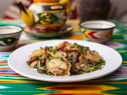  Fried potatoes with pieces of meat. Asian style