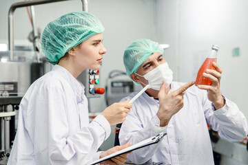 Quality control and food safety team inspection the product standard in the food and drink factory production line.