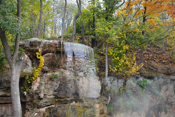 Autumn colors in the National Dendrology Park of Sofiyivka, Uman, Ukraine. Waterfall in the park.