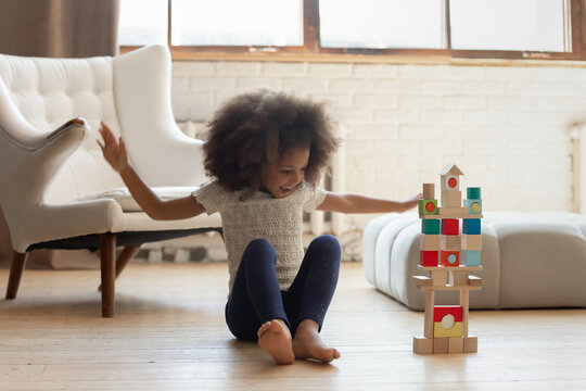 I Did It Excited Overjoyed African American School Aged Girl Screaming In Delight Happy Of Building High Beautiful Stable Brick Castle On Floor, Feeling Proud Of Achievement, Calling Parents To See