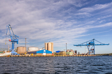 Massive blue crane unload cargo in a seaport in Sweden
