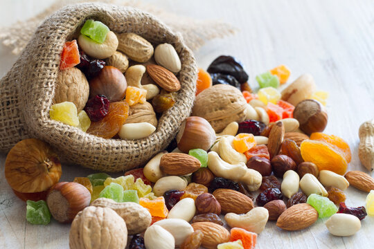 Mix of nuts and dried fruits on light background