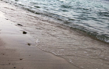Beautiful Rock and soft wave sea on the beach in Thailand.
