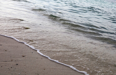 Beautiful Rock and soft wave sea on the beach in Thailand.