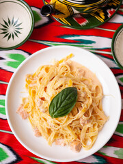 creamy pasta with chicken, basil and mushrooms, according to the Italian recipe. East style
