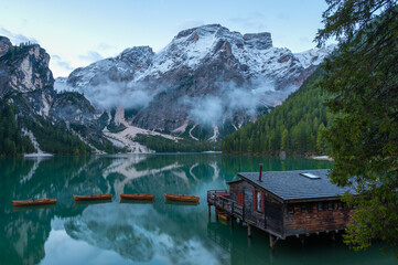 High angle view of iconic boathouse and boats with mount Seekofel mirroring in the clear calm water of Pragser Wildsee (Lago di Braies) in Dolomites, Unesco World Heritage, South Tyrol, Italy