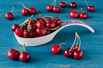 Fresh cherries on a blue wooden table
