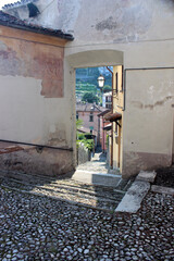 Through the small entrance you can see the typical Italian houses of a small village.