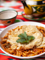  The oriental lagman dish is homemade noodles fried with meat, vegetables and herbs. Eastern cuisine