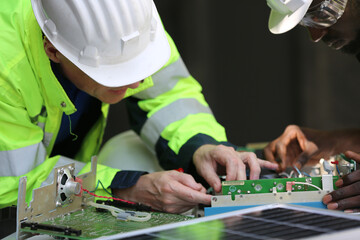 Engineer working on checking and maintenance equipment at solar panels power farm, photovoltaic cell park, green energy concept.