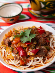  The oriental lagman dish is homemade noodles fried with meat, vegetables and herbs. Eastern cuisine