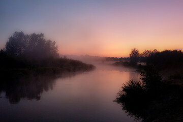 Fototapeta na wymiar Morning on the river early morning reeds mist fog and water surface on the river.