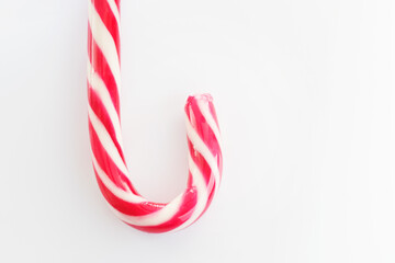 Mint hard candy cane striped in Christmas colours Red and White isolated on white background. Traditional Merry Christmas edible decoration.