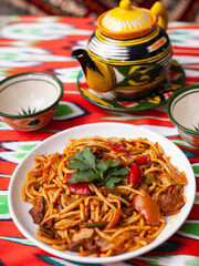  The oriental lagman dish is homemade noodles fried with meat, vegetables and herbs. Eastern cuisine