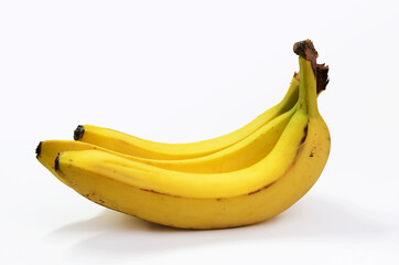 Three ripe, sweet yellow bananas on a white background