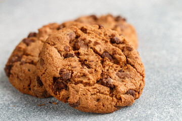 Freshly baked homemade crunchy cookies with chocolate chips, peanut butter or salted caramel. A delicious treat for gourmets. Biscuits close-up. Selective focus, shallow depth of field