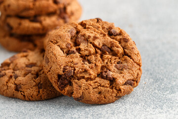 Freshly baked homemade crunchy cookies with chocolate chips, peanut butter or salted caramel. A delicious treat for gourmets. Biscuits close-up. Selective focus, shallow depth of field