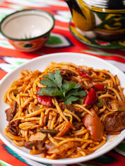  The oriental lagman dish is homemade noodles fried with meat, vegetables and herbs. Eastern cuisine