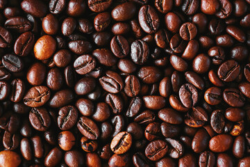 Top view of a many of aromatic quality roasted coffee beans. Background. Coffee harvest.