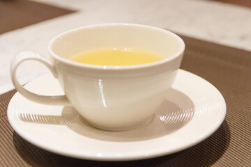 Cup of tea on the table with blur background at cozy cafe and restaurant.