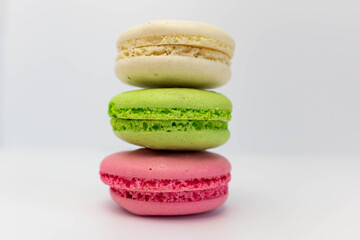 Macaroons isolated on the white background.Homemade french style colorful macaroons. Green, white, pink cookies.