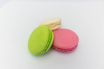 Macaroons isolated on the white background.Homemade french style colorful macaroons. Green, white, pink cookies.