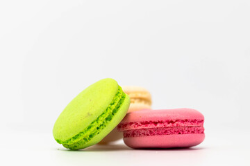 Macaroons isolated on the white background.Homemade french style colorful macaroons. Green, white, pink cookies.