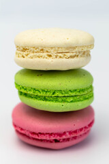 Macaroons isolated on the white background.Homemade french style colorful macaroons. Green, white, pink cookies.