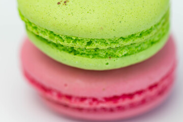 Macaroons isolated on the white background.Homemade french style colorful macaroons. Green, white, pink cookies.