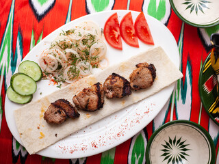 chicken kebab - charcoal grilled chicken breast.Served with vegetables, pickled onions, lavash bread and oriental sauce