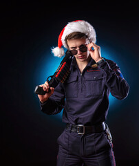 a man in a police uniform with a shotgun and a Santa hat for the new year holiday