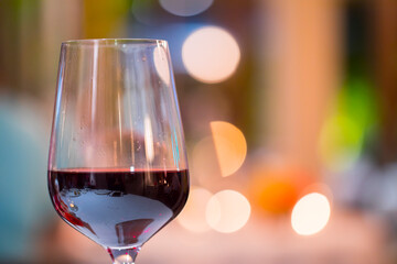 Glass of red wine with bokeh