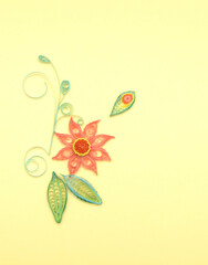 Quilling paper flower on bright yellow background