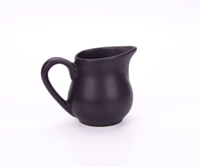 Black ceramic pitcher on white background.