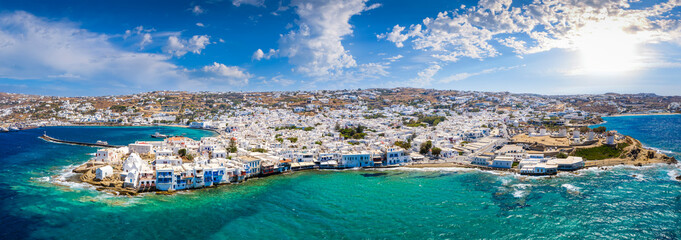 Wide aerial panorama of the town of Mykonos island, Greece, with the little venice district, the famous windmills and the old port - obrazy, fototapety, plakaty