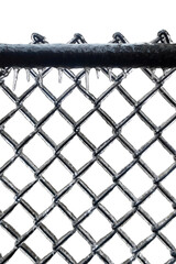 Chain link fence covered by freezing rain isolated