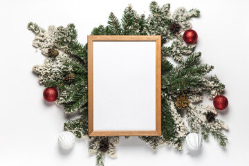 Fototapeta na wymiar Empty wooden frame for christmas and new year menu form or invitation with fir branches and decoration. Flat lay winter holidays concept. Top view