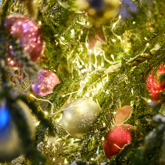 Ornament from red balls, garlands and green christmas tree for the New Year holiday