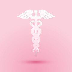 Paper cut Caduceus medical symbol icon isolated on pink background. Medicine and health care concept. Emblem for drugstore or medicine, pharmacy snake. Paper art style. Vector.