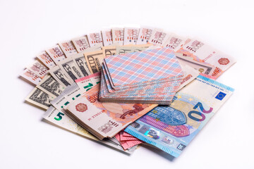 American dollars, euros, rubles and playing cards on top on a white background. Games of chance.