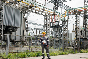 The energy engineer inspects the equipment of the substation. Power engineering. Industry