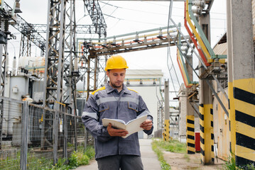 The energy engineer inspects the equipment of the substation. Power engineering. Industry