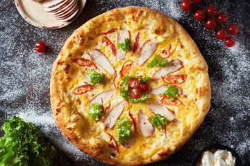 Caesar pizza with chicken breast, mozzarella cheese and tomatoes.