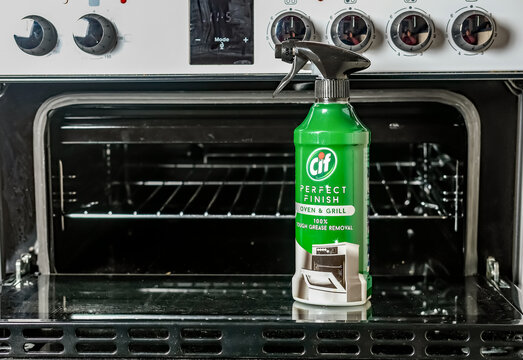 Norwich, Norfolk, UK &ndash; November 28 2020. An illustrative editorial photo of a bottle of Cif perfect finish oven and grill cleaner in front of a dirty domestic oven