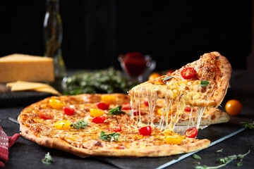 Pizza margarita with mozzarella cheese and tomatoes on a dark background, top view, flat lay