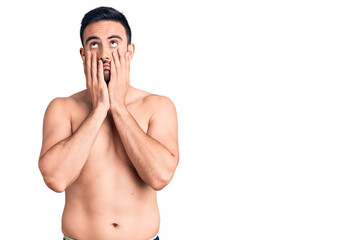 Fototapeta premium Young handsome man wearing swimwear tired hands covering face, depression and sadness, upset and irritated for problem