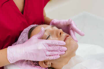 A young pretty girl is enjoying a professional head massage at the Spa. Body care. Beauty salon