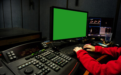 Men edit videos in a dark studio using modern color grading tools and equipment.Selective...