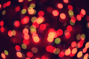 Toned blurred bokeh background of colorful garland lights